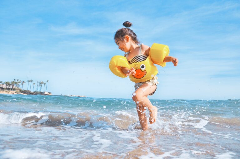 child splashing on the beach