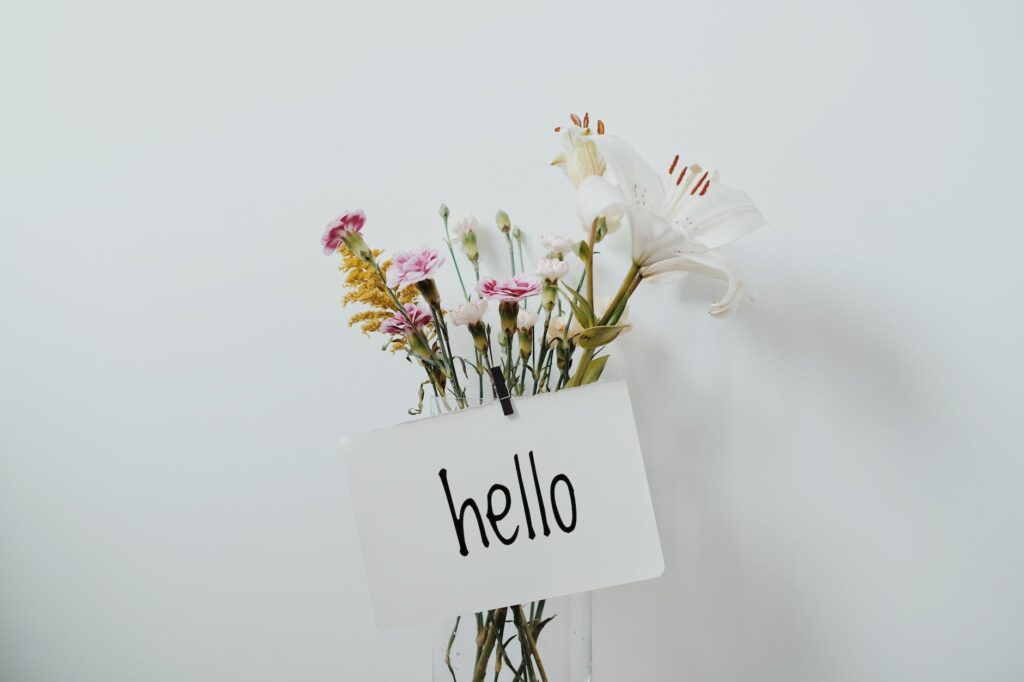 bunch of flowers with a hello sign