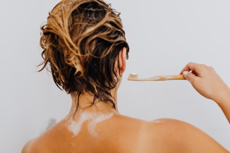 woman with wet hair brushing her tee