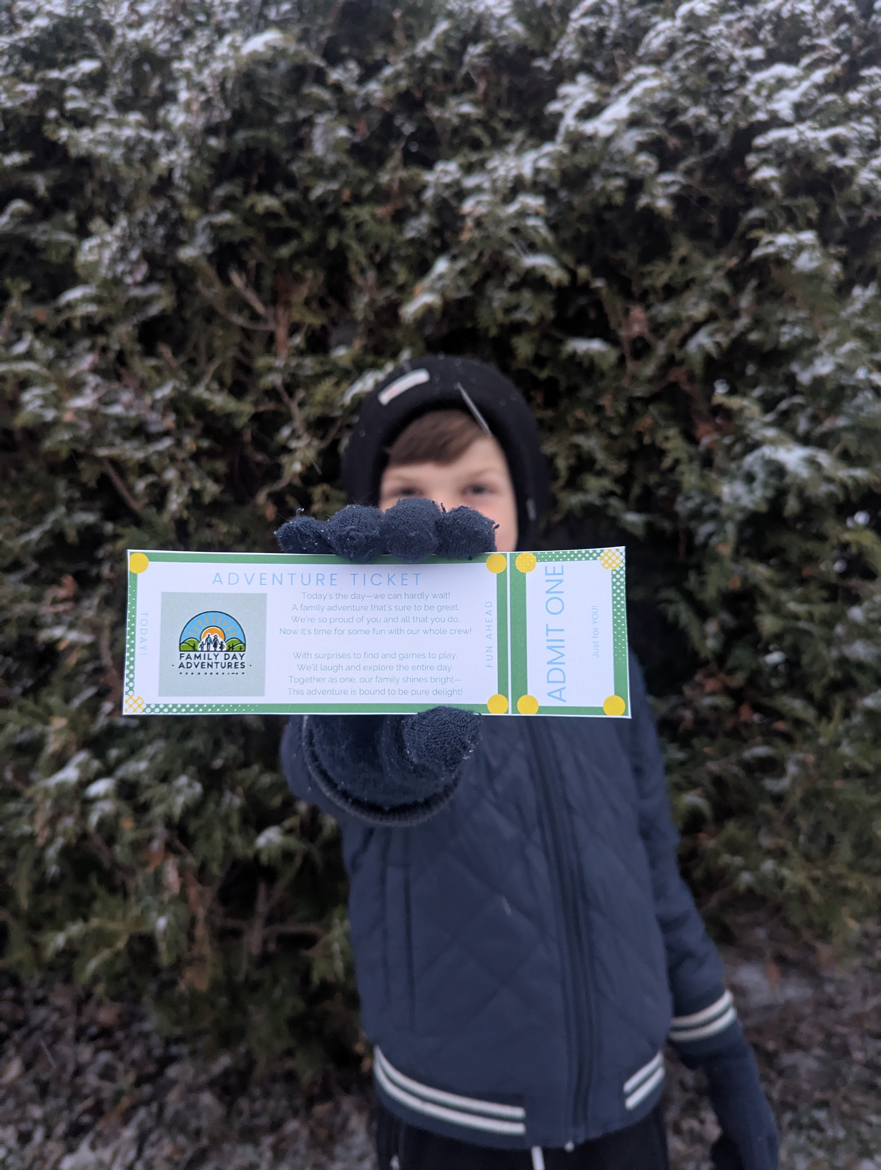 boy holding up family day adventure ticket