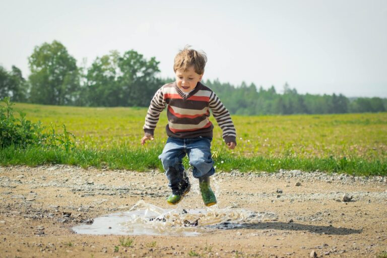 boy jumping near grass spring activity